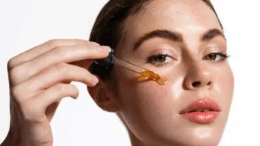 Close up of a woman putting Vitamin C serrum on her face, representing the Dr. Dennis Gross Skincare settlement.