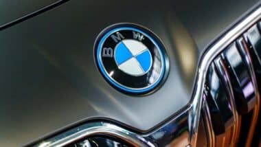 Close up of a BMW emblem on a front bumper, representing the BMW recalls and class action.