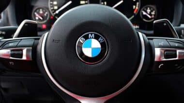 Close up of a BMW steering wheel, representing the BMW recall.