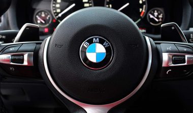 Close up of a BMW steering wheel, representing the BMW recall.