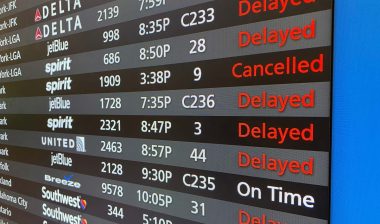 Close up of canceled and delayed flights on a flight board in an airport, representing the CrowdStrike class action.