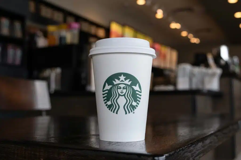 Close up of a Starbucks coffee cup sitting on a table, representing the Starbucks lawsuit.