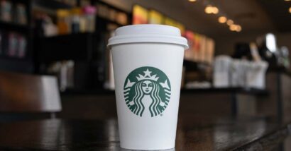Close up of a Starbucks coffee cup sitting on a table, representing the Starbucks lawsuit.