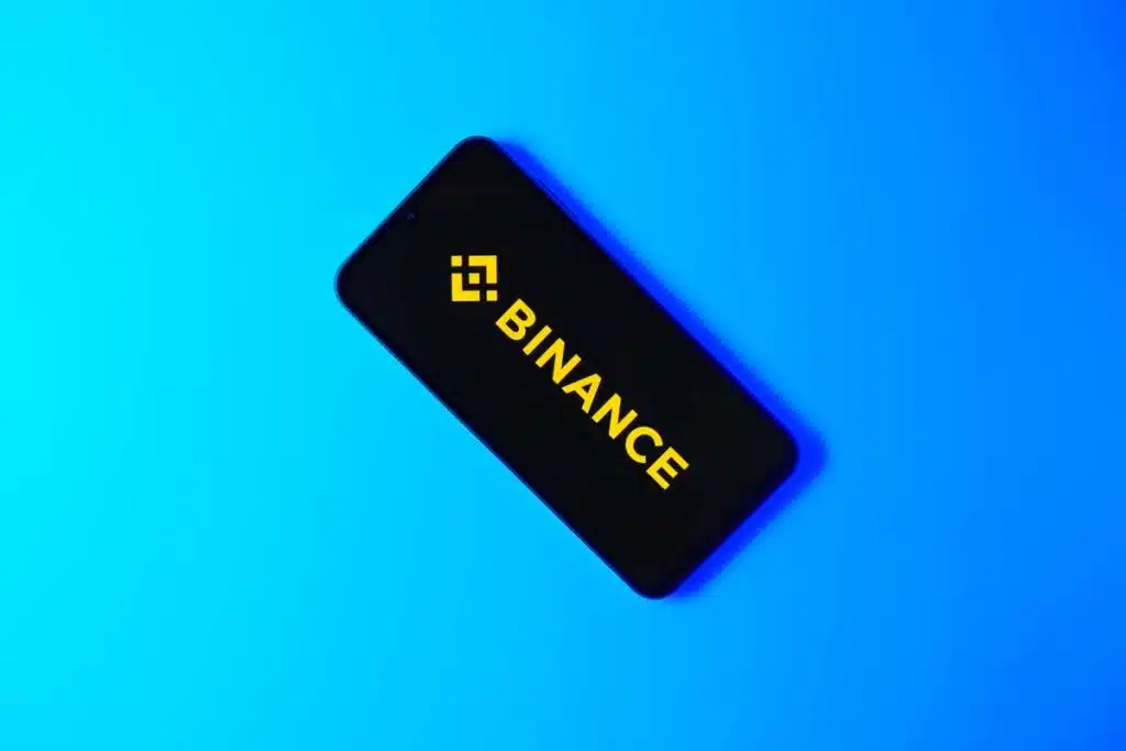Binance logo displayed on a smartphone screen, representing the Binance class action.