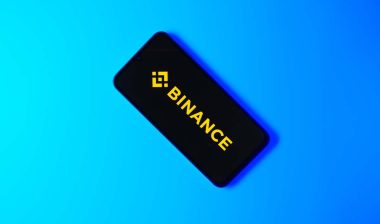 Binance logo displayed on a smartphone screen, representing the Binance class action.