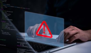 Close up of a man typing on a laptop with a data breach concept overlay, representing the National Public Data class action.