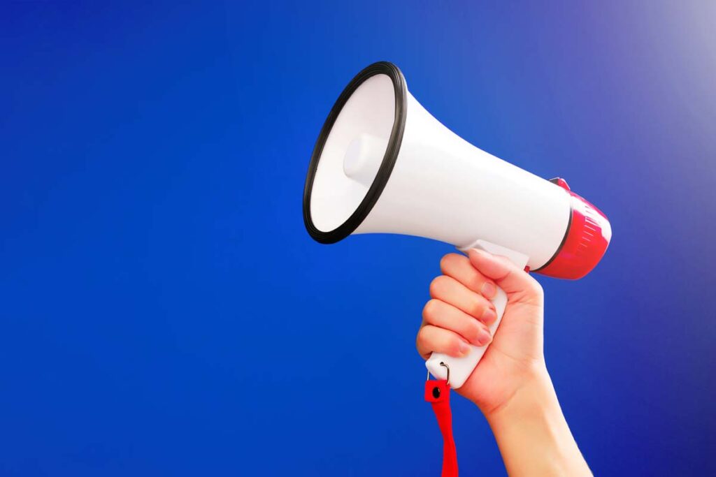 Close up of a hand holding a megaphone, representing top recalls for the week of Sept. 16.