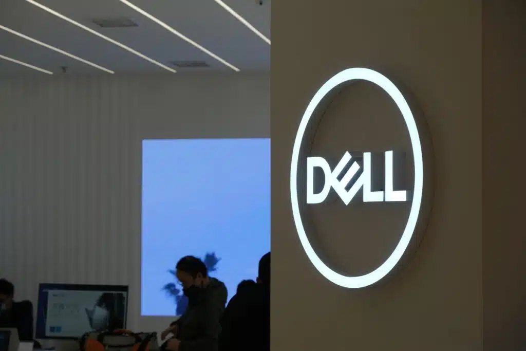 A Dell computers signs hangs on a wall