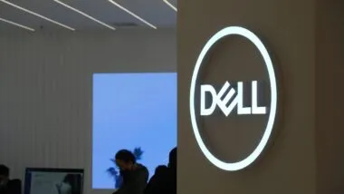 A Dell computers signs hangs on a wall