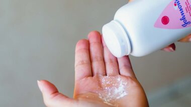 Close up of a woman pouring Johnson & Johnson powder into her hand, representing the J&J talc verdict.