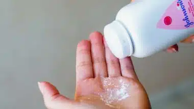 Close up of a woman pouring Johnson & Johnson powder into her hand, representing the J&J talc verdict.