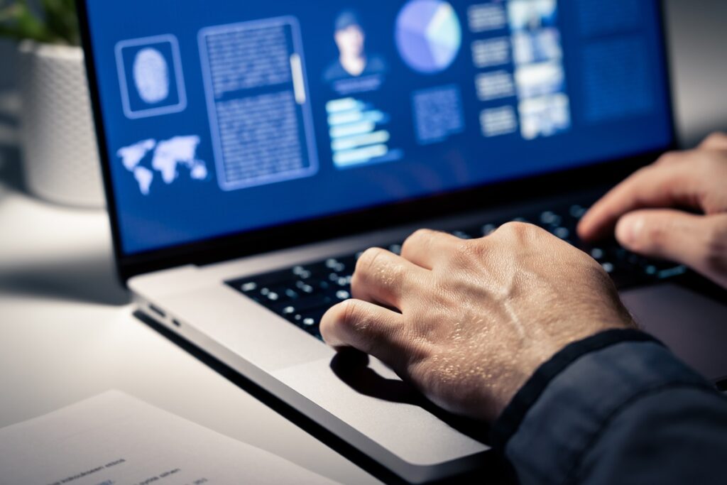 a man on a computer representing the National Public Data class action.