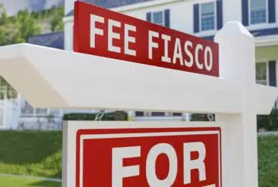 "Fee Fiasco" on a for sale sign in front of house.