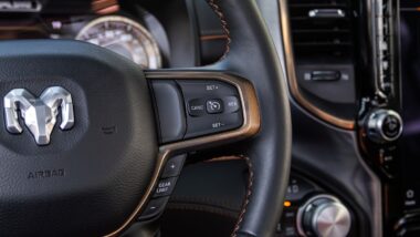 Dodge Ram 1500 steering wheel inside truck representing the Ram 1500 class action.