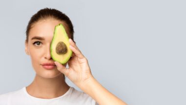 Girl holding up an avocado representing the Walmart class action.