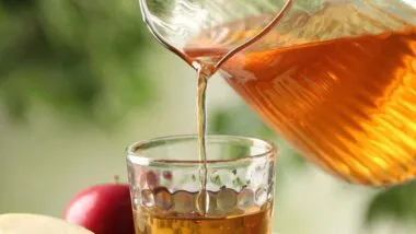 Close up of apple juice being poured into a cup, representing beverage class actions.