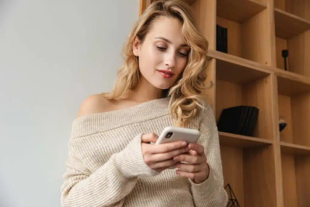 A woman using her smartphone, representing the dating site class action.