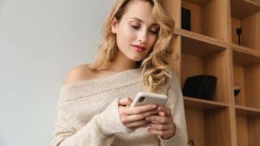 A woman using her smartphone, representing the dating site class action.