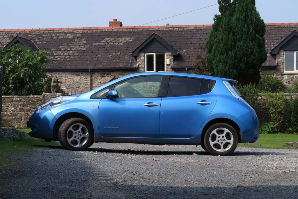 Side view of a blue Nissan Leaf, representing the Nissan recall.