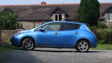 Side view of a blue Nissan Leaf, representing the Nissan recall.