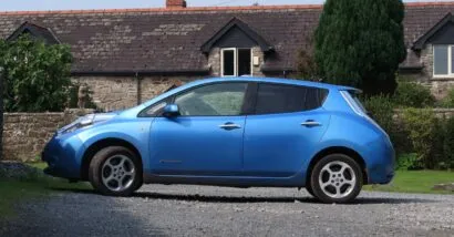 Side view of a blue Nissan Leaf, representing the Nissan recall.