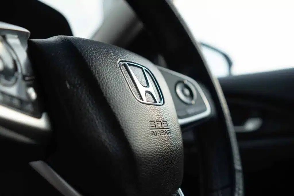 Close up of a Honda steering wheel, representing the Honda recall.