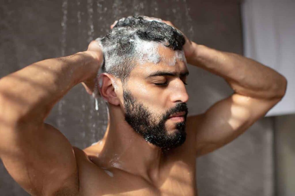 A man washing his hair in the shower, representing the Dr. Squatch class action.
