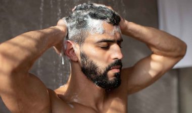 A man washing his hair in the shower, representing the Dr. Squatch class action.