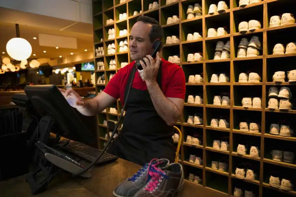 A worker working at a bowling alley, representing the AMF Bowling Centers settlement.