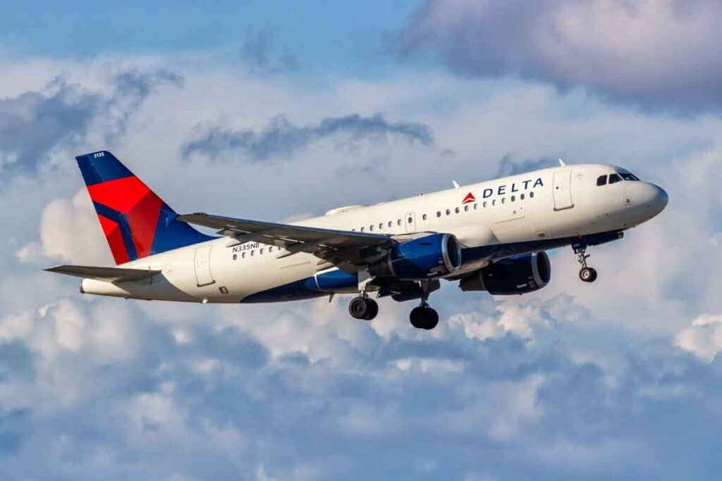 A Delta airlines plane in the sky, representing the Delta lawsuit.