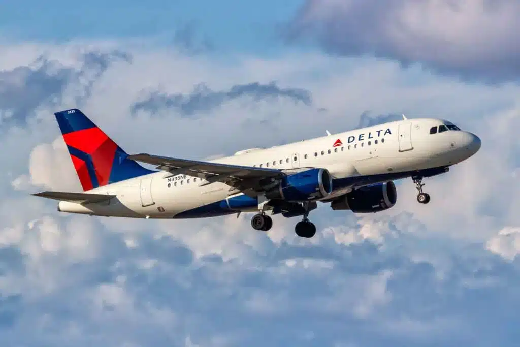 A Delta airlines plane in the sky, representing the Delta lawsuit.