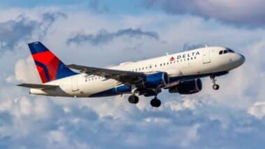 A Delta airlines plane in the sky, representing the Delta lawsuit.