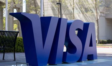 Visa credit card logo in big letters outside headquarters representing the Visa lawsuit.
