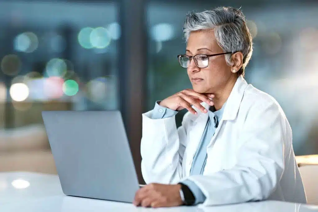 A doctor using a laptop, representing the Albany ENT & Allergy Services settlement.