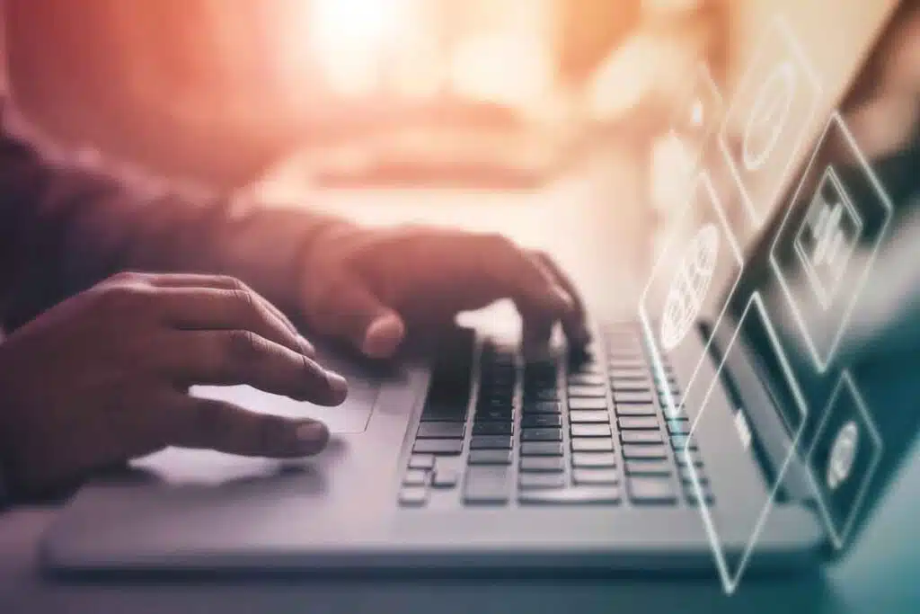 Close up of hands typing on a laptop, representing the Receivables Performance Management settlement.
