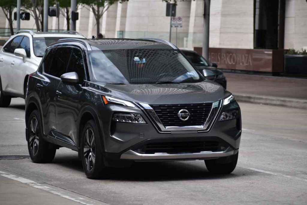 A Nissan Rogue driving along a road, representing the Nissan recall.