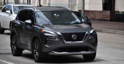 A Nissan Rogue driving along a road, representing the Nissan recall.