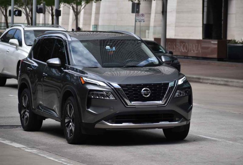 A Nissan Rogue driving along a road, representing the Nissan recall.