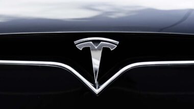 Close up of Tesla emblem, representing Tesla recalls.