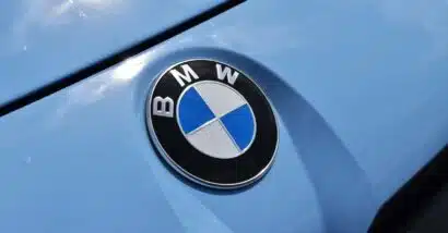 Close up of a BMW emblem on a front bumper, representing the BMW class action.