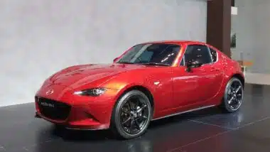 A red Mazda Miata at a car show, representing the Mazda recall.