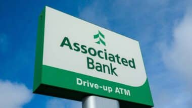 Close up of Associated Bank signage, representing the Associated Bank NSF fees investigation.