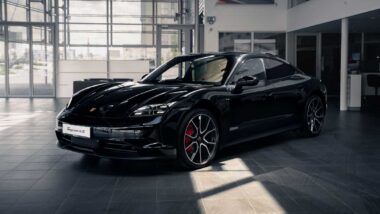 A black Porsche Taycan in a showroom, representing the Porsche recall.