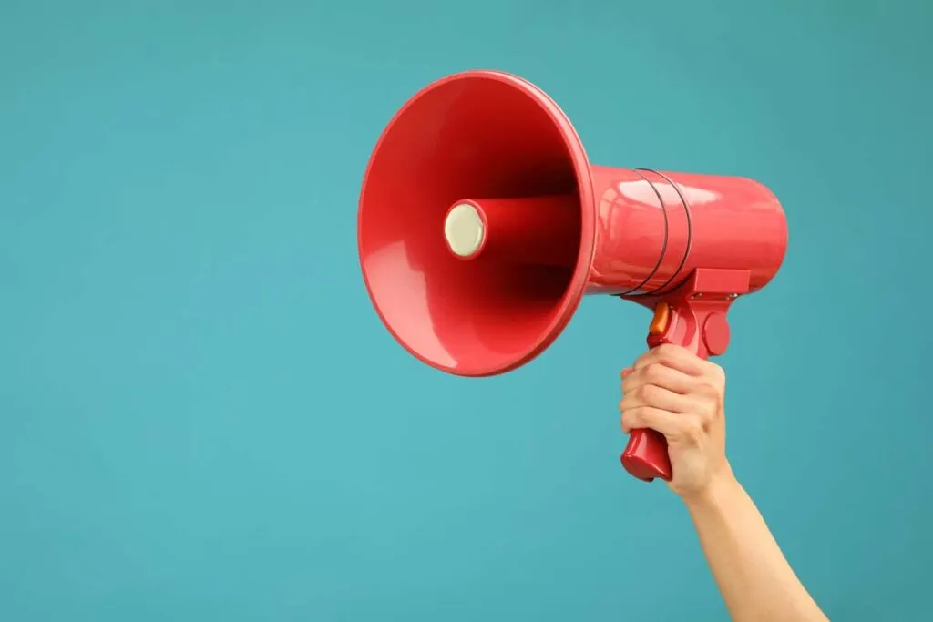 Close up of a hand holding a megaphone, representing top recalls for the week of Sept. 30.