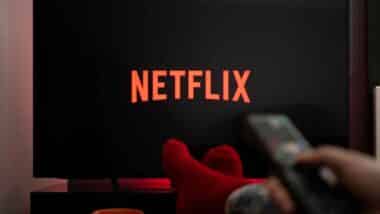 A person watching Netflix on a TV, representing the Netflix class action.