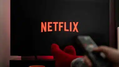 A person watching Netflix on a TV, representing the Netflix class action.