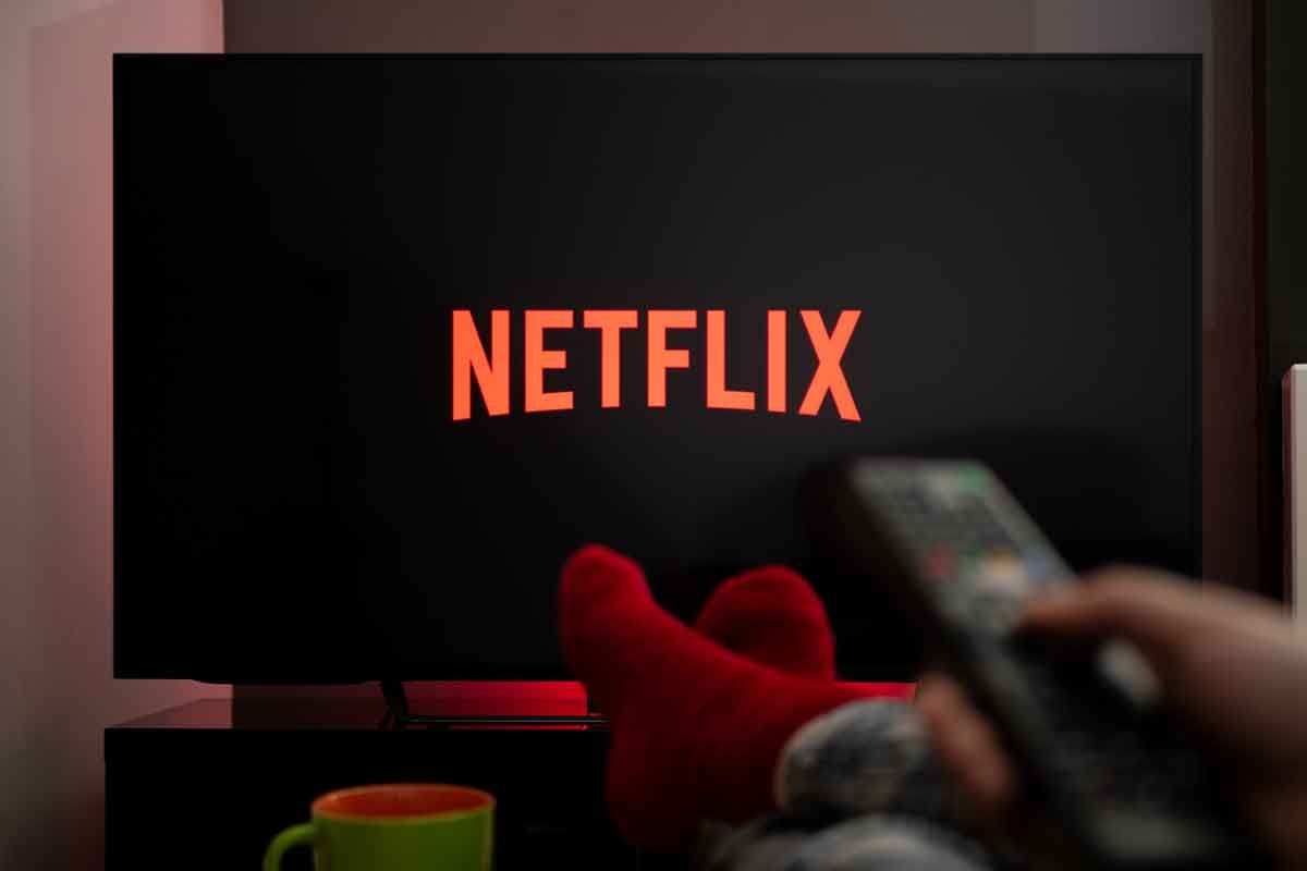 A person watching Netflix on a TV, representing the Netflix class action.