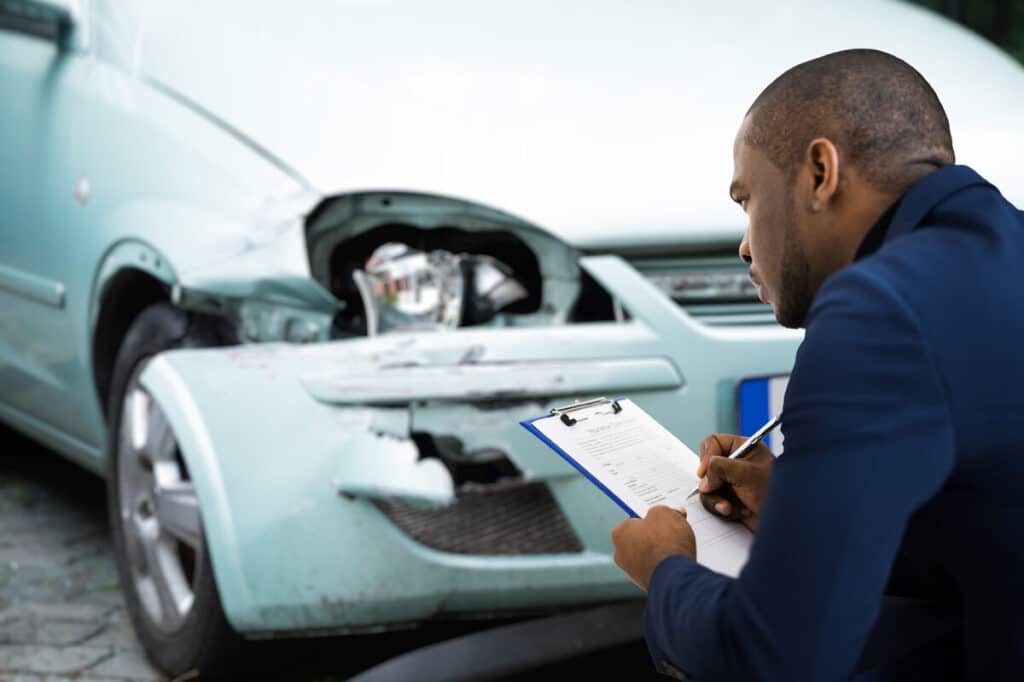 Progressive insurance adjuster assess damage representing the Progressive Michigan settlement.