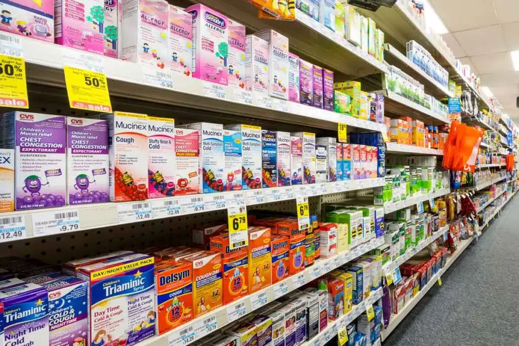 An over the counter medication aisle in a store, representing OTC medication class actions and settlements.