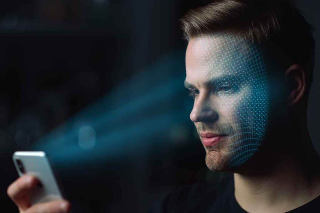 A man taking a selfie with his smartphone with a face scan overlay, representing the Incode Technologies settlement.